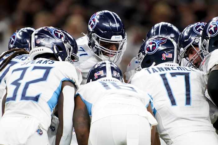 The Tennessee Titans offense huddles up against the New Orleans Saints at Caesars Superdome.